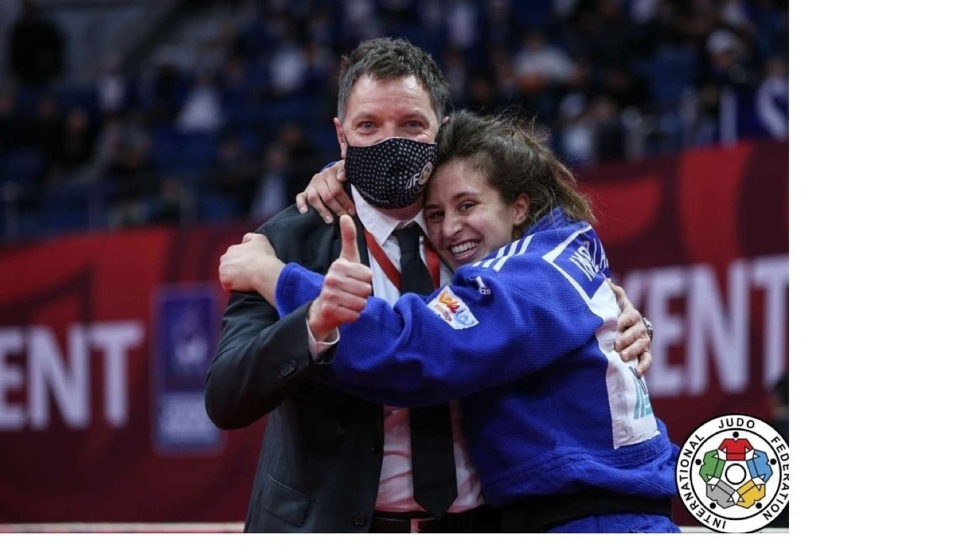 The Israeli judo team celebrates on the mat with their mixed-team bronze medals at the Tokyo 2020 Olympic Games.